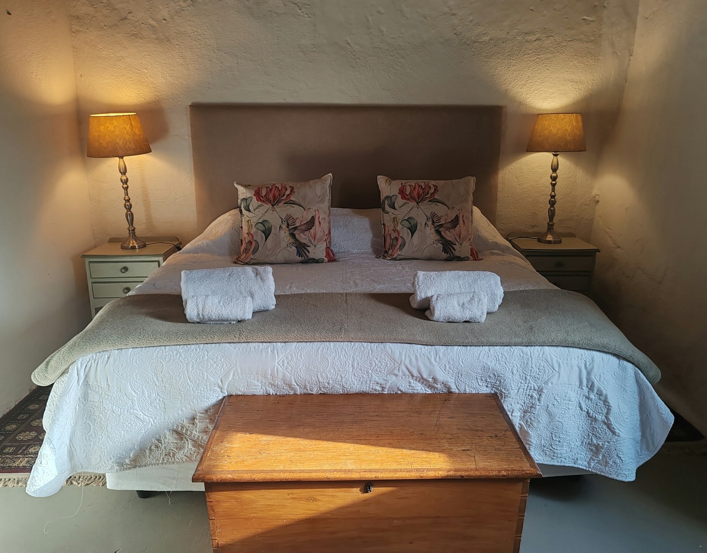 A Muldersvlei guest room with twin beds, crisp white linen and the character of the converted stable