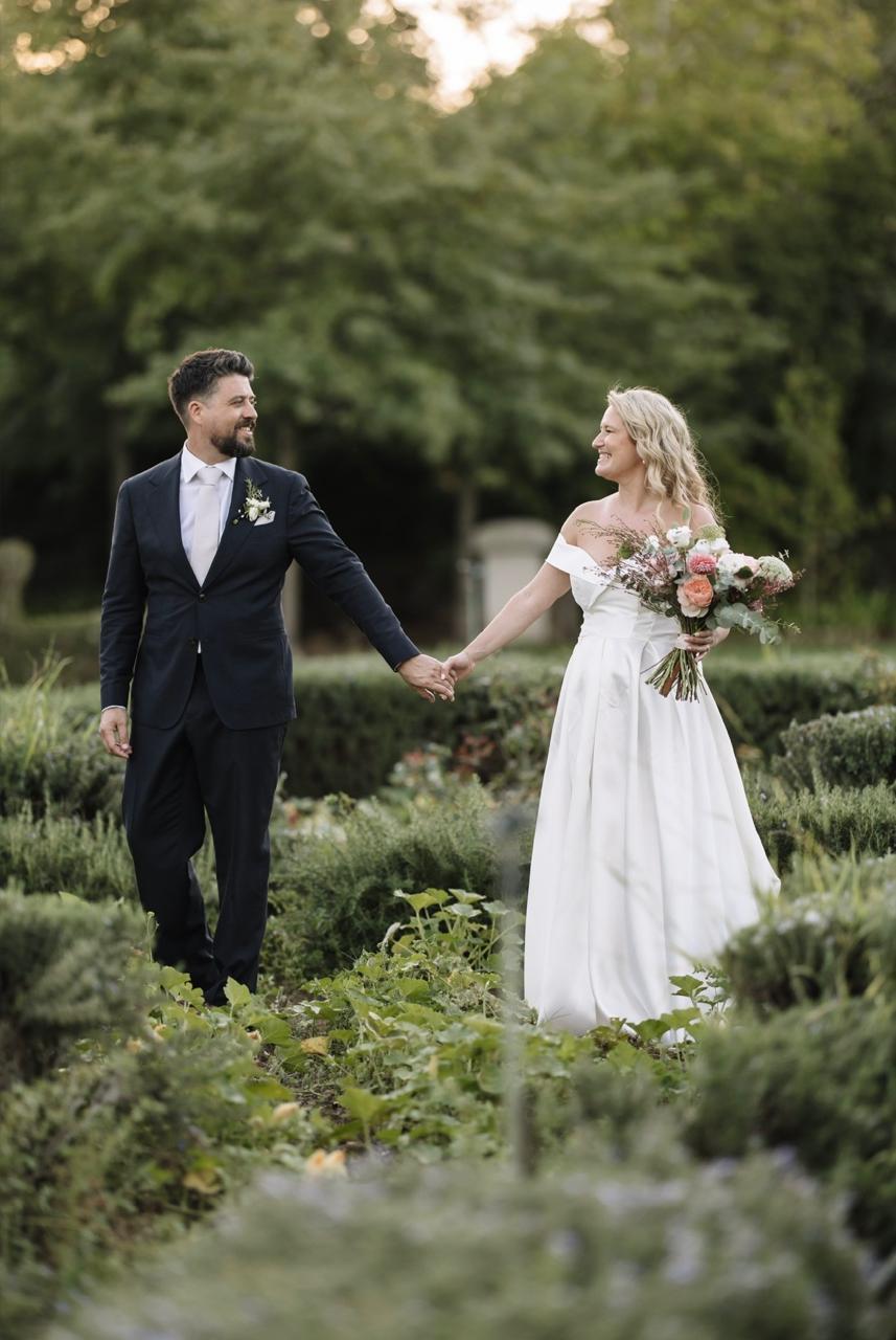 A newly married couple walking through the herb garden at Muldersvlei