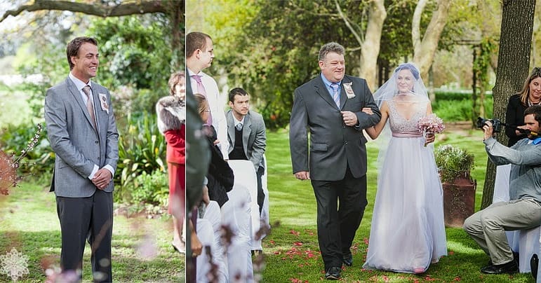 A groom waiting as the bride walks down the petal-strewn aisle on her father's arm at a Muldersvlei garden ceremony