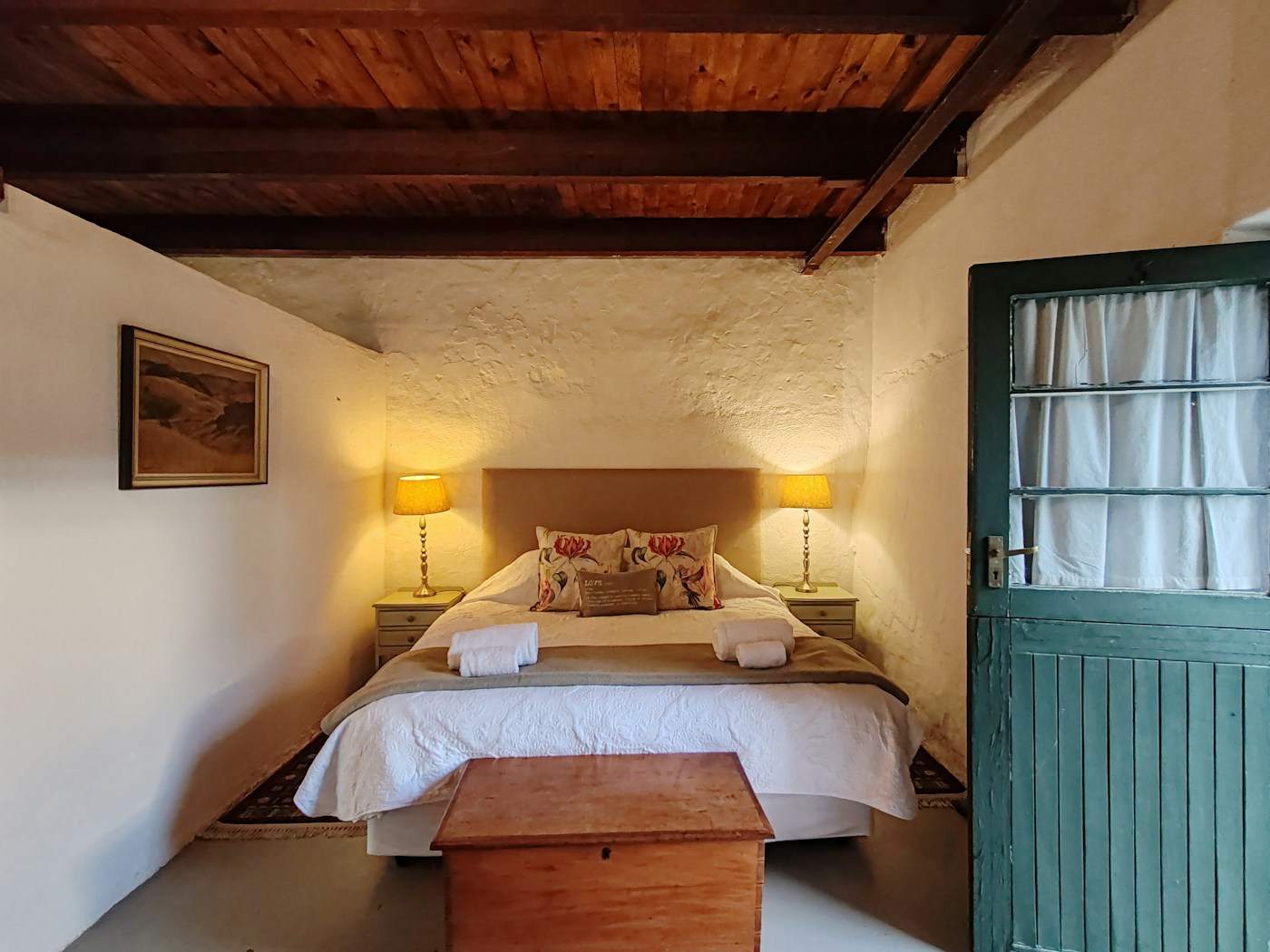 A real Muldersvlei guest room with white linen and a stable door opening to the garden
