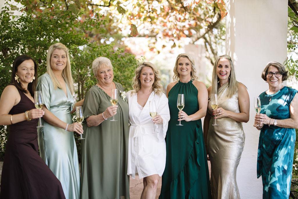Family and friends raising champagne glasses together at Muldersvlei